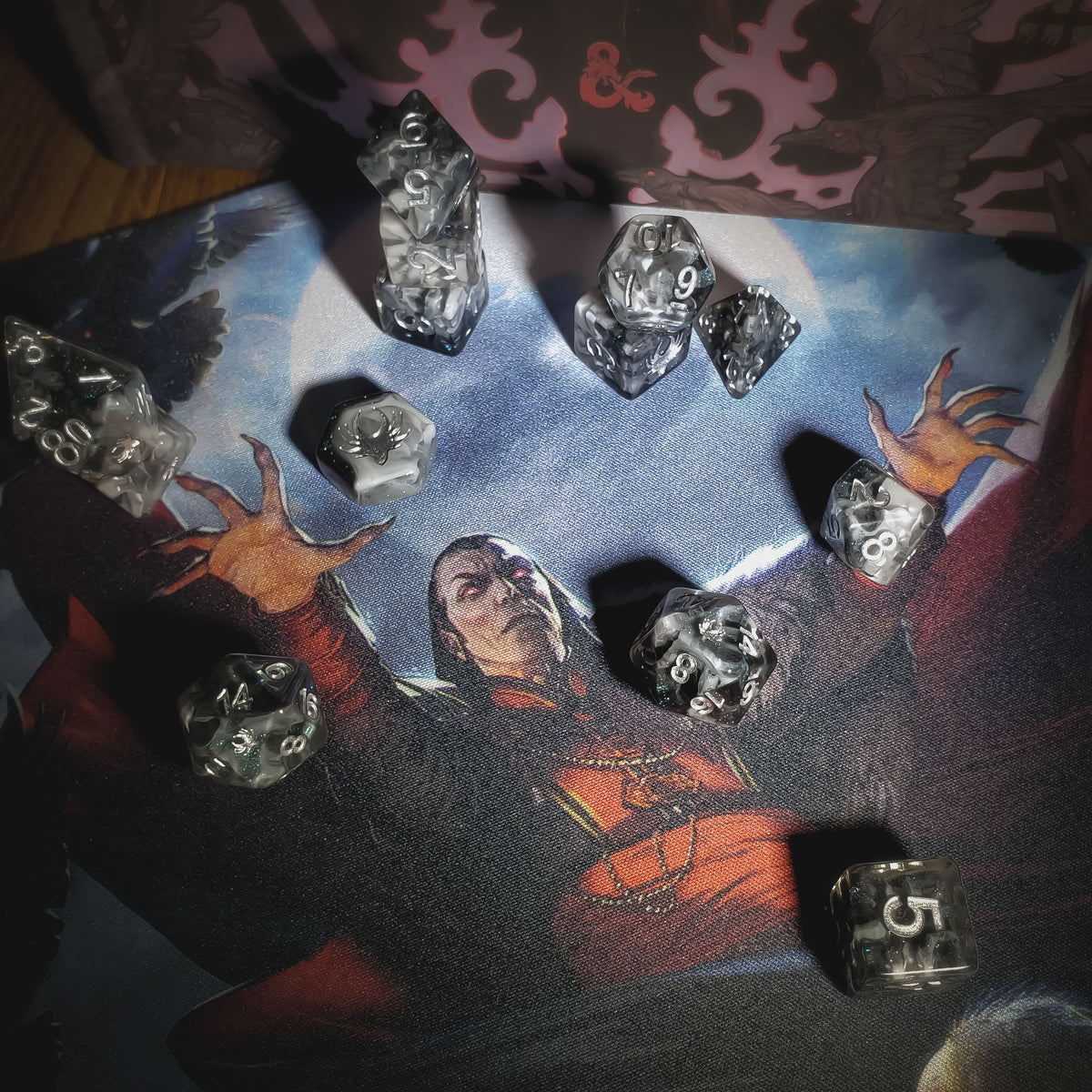 Dice on a table with a fantasy-themed mat