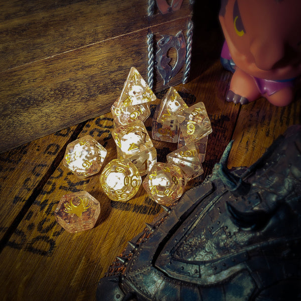 Set of transparent dice with star patterns on a wooden surface with a toy figure and armor.