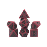 Set of red and black polyhedral dice on a white background