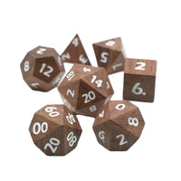 Wooden polyhedral dice set with white numbers on a white background