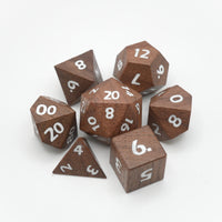 Set of wooden polyhedral dice with white numbers on a white background