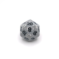 D20 polyhedral dice with speckled gray and black design on a white background