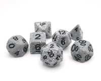 Set of gray polyhedral dice with black numbers on a white background