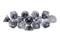Set of gray polyhedral dice with numbers on a white background
