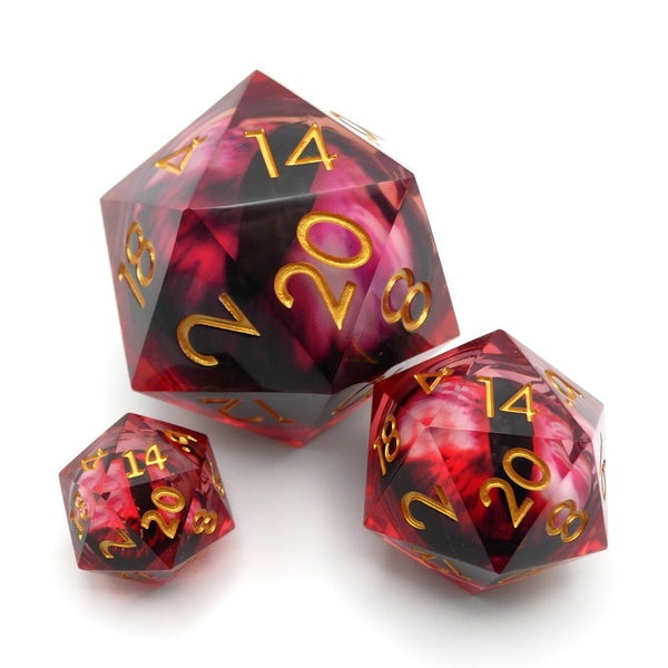 Set of red and black polyhedral dice with gold numbers on a white background