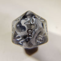 Close up of a single Misty Step d20 die showing 20 on a light surface