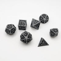Set of metallic dice with embossed designs on a white background