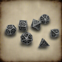 A set of seven silver-toned polyhedral RPG dice with dark engraved details and occult symbols, arranged on a textured beige parchment background.