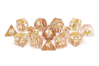 Set of dice with gold and clear design on a white background