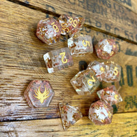 Set of dice with gold numbers on a wooden surface