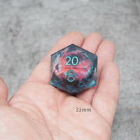 Polyhedral dice with colorful swirl pattern held in a hand against a gray background