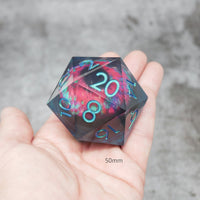 D20 polyhedral dice with colorful numbering held in a hand against a gray background