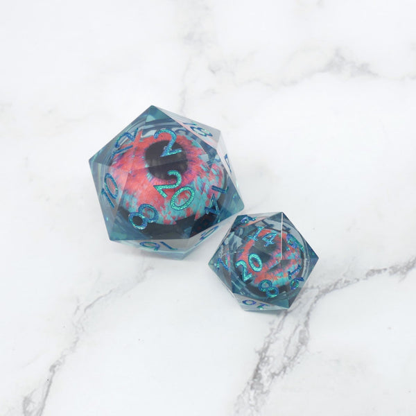 Two polyhedral dice with a colorful design on a marble surface